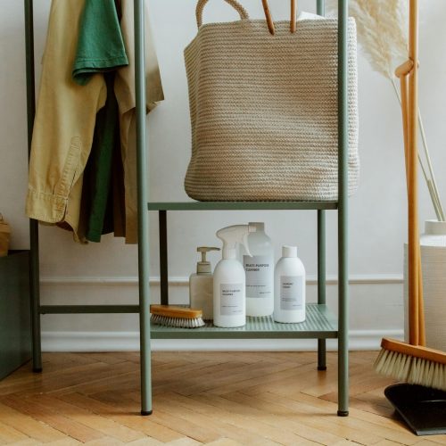 Eco-friendly cleaning products and home storage solutions in a modern, minimalist interior.