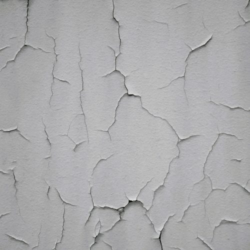 Detailed shot of a cracked and weathered wall showing decay and surface texture.