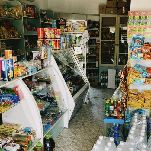 Interior view of a cozy retail store in Shymkent, Kazakhstan, showcasing diverse merchandise.