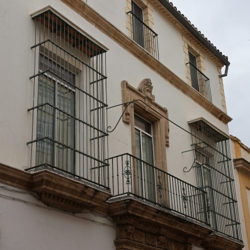 A classic Andalusian building facade in El Puerto de Santa María, Spain showcasing traditional architecture.