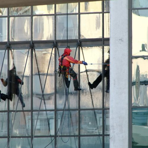 Professional window cleaners working on a skyscraper's exterior in Saint Petersburg, Russia.